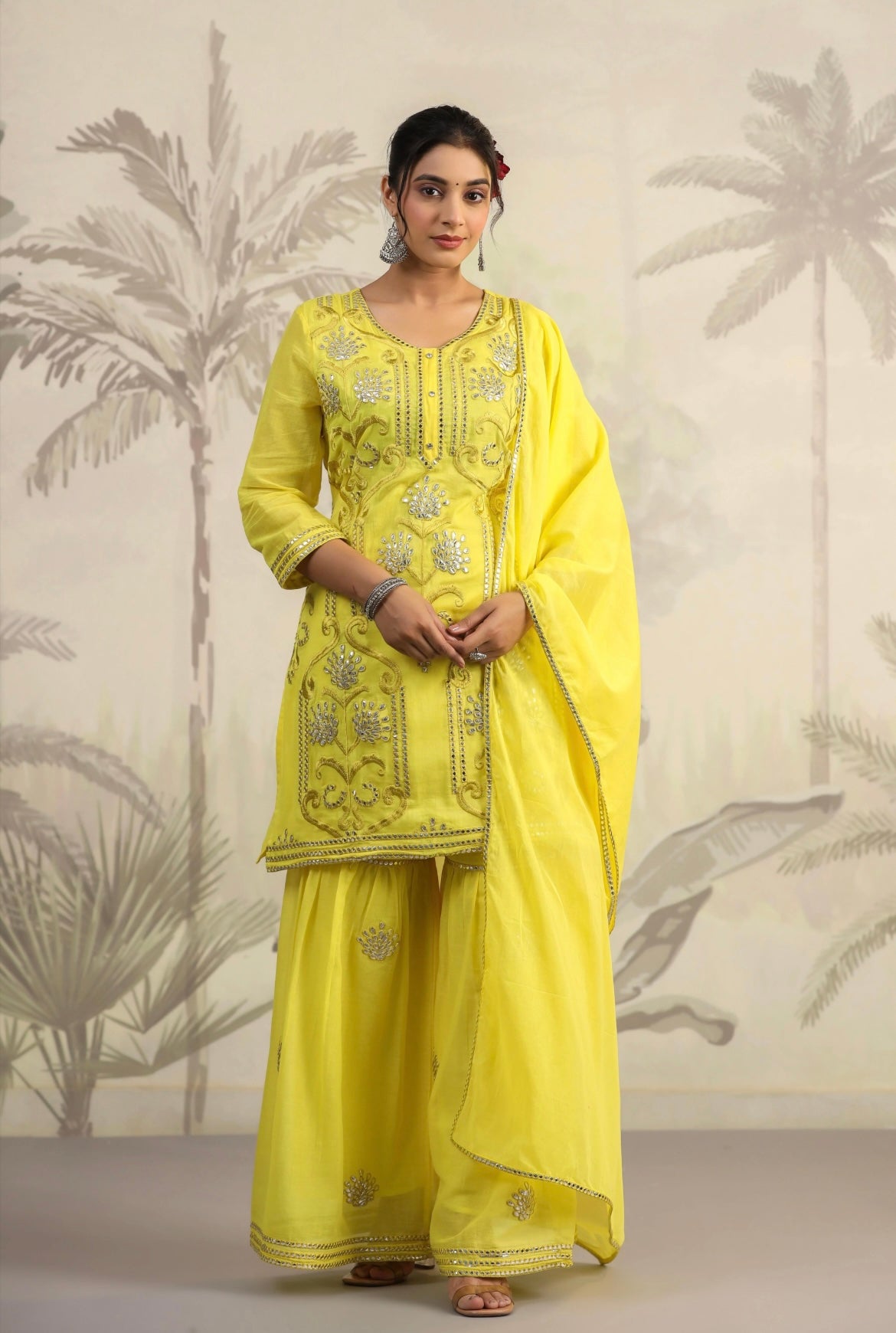 Cotton women’s pant suit in mulmul. Sharara suit with full embroidery in yellow colour. Front view.