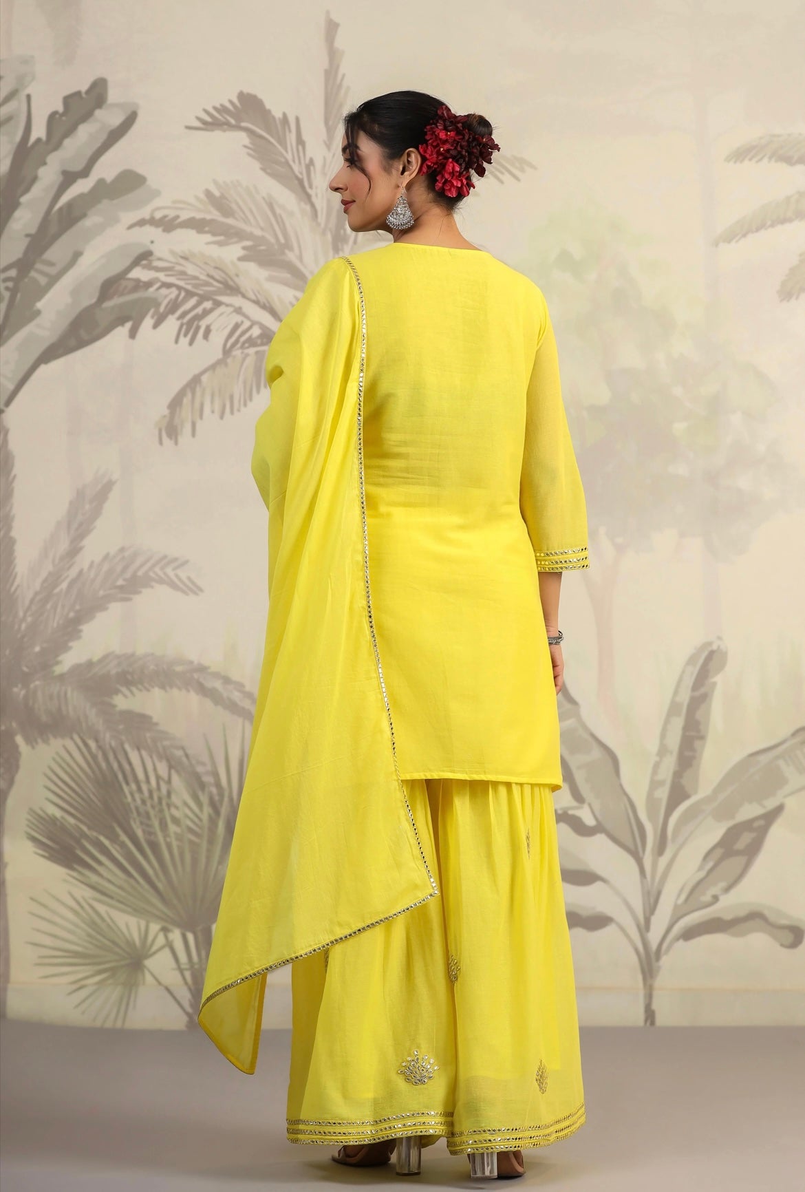 Cotton women’s pant suit in mulmul. Sharara suit with full embroidery in yellow colour. Back view.