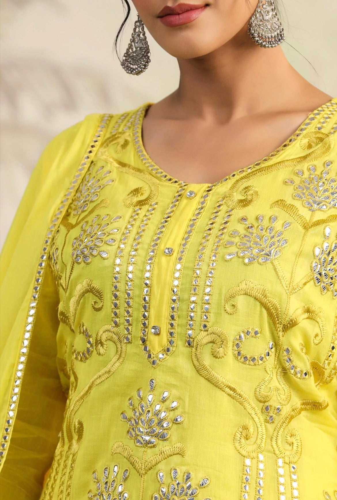 Cotton women’s pant suit in mulmul. Sharara suit with full embroidery in yellow colour. Front embroidery view.