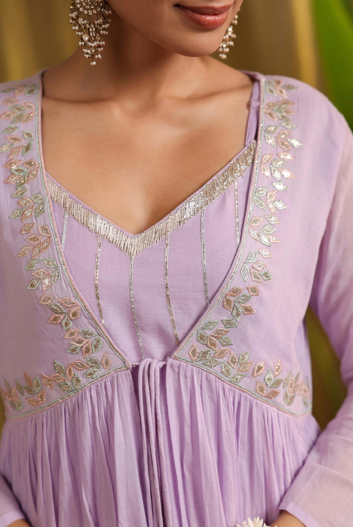 Indo western dress with shrug made in mulmul cotton embroidered with Gota work. Lavender colour with beautiful tassels. Zoomed front details.