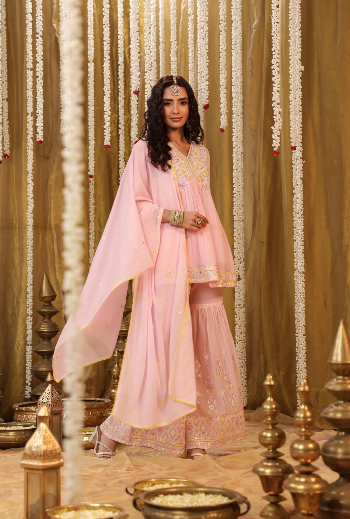 Cotton kurta peplum style in Baby Pink colour with sequins embroidery and intricate contrast yellow thread work. Accompanied by sharara pants. Right view.