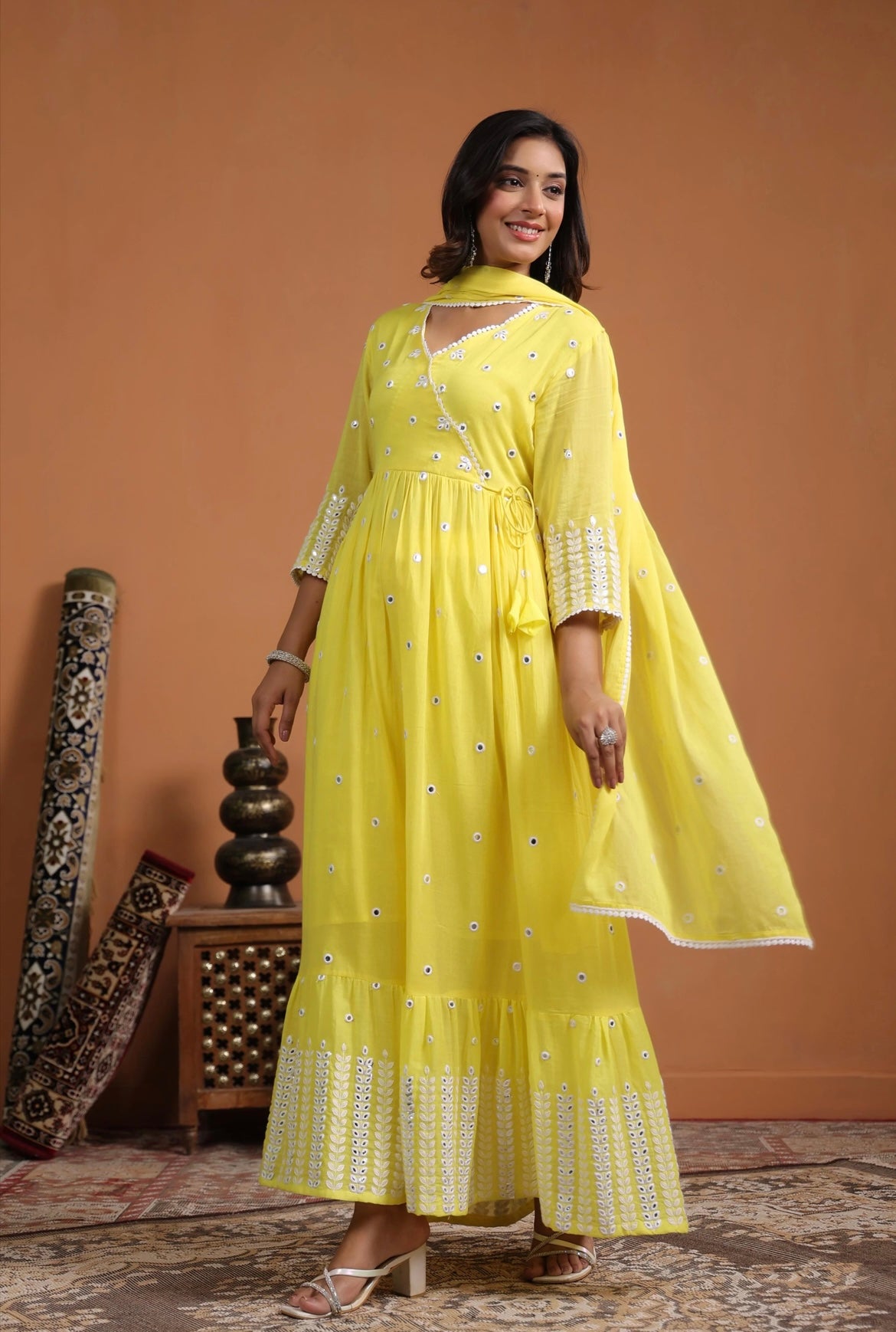 Anarkali dress, anarkali gown. Angrakha style. Yellow colour. Side view.