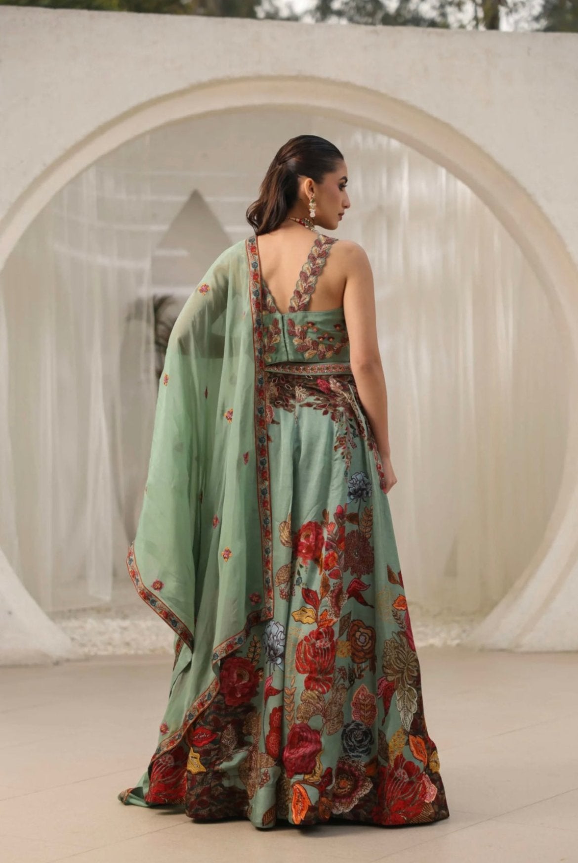 Lehenga choli for women in best price made with organza fabric and embellished with hand work. It’s printed with delicate hand embroidery best for wedding lehenga. Back View.