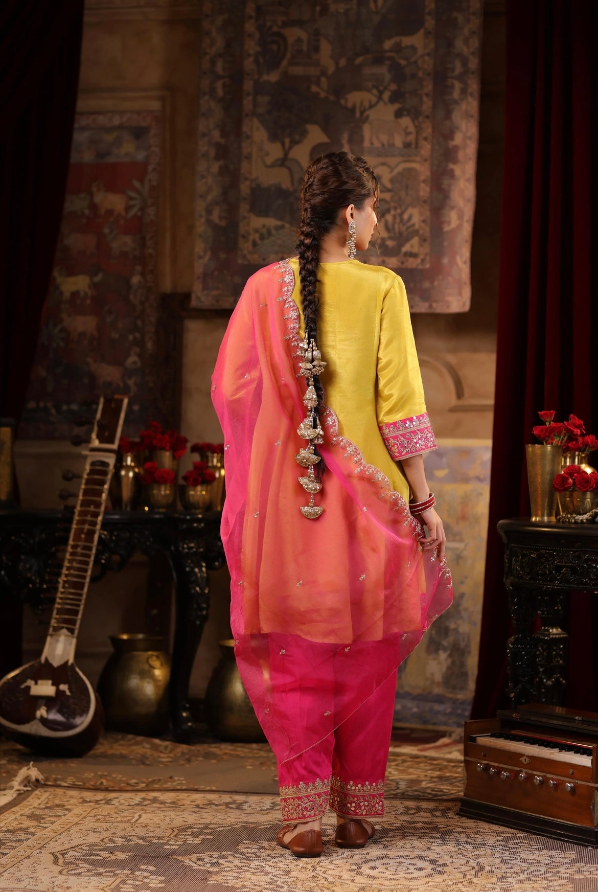 Lime Anarkali with Fuchsia Salwar set adorned with Dori and Gota embroidery. Back view.