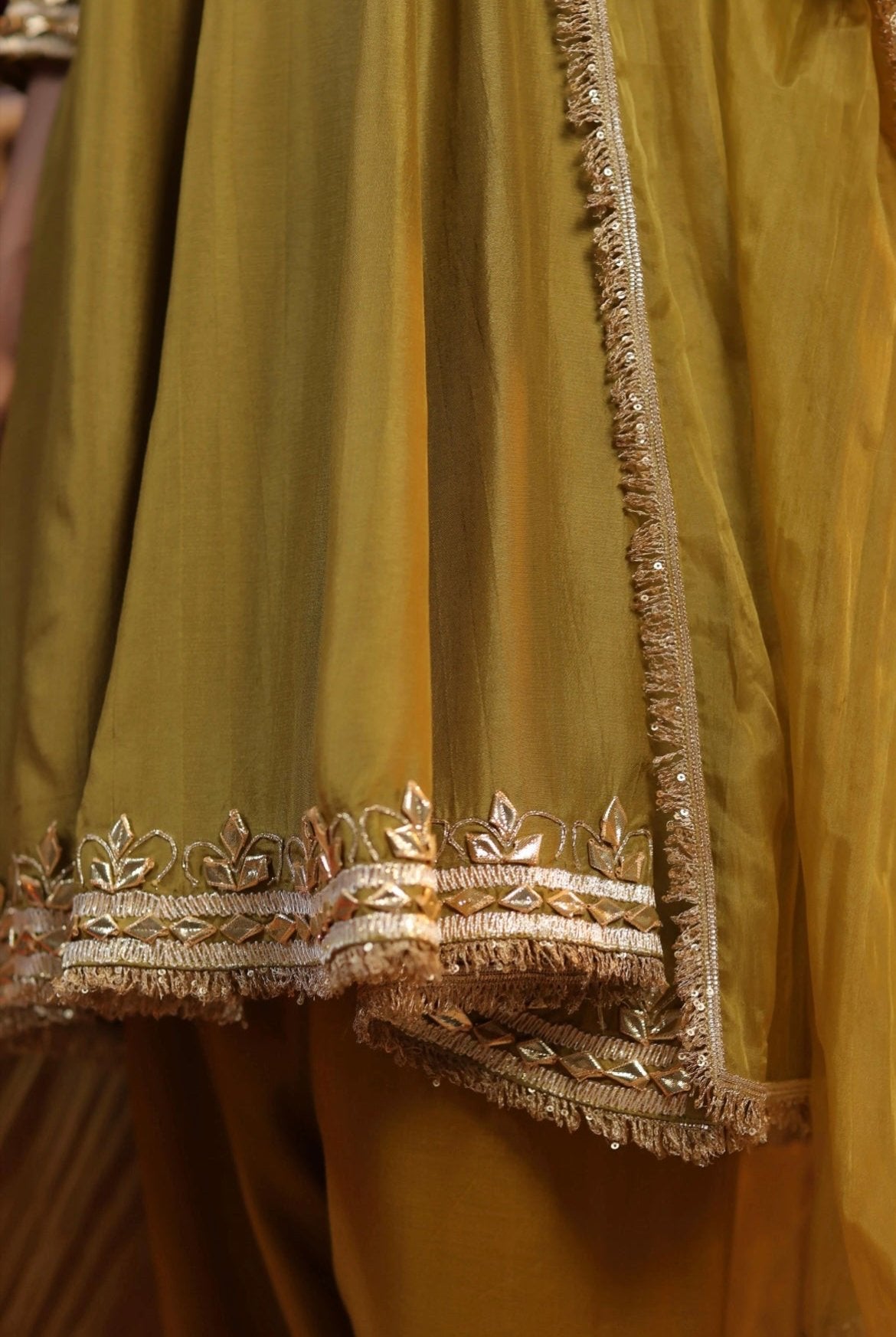 Olive Silk Anarkali Salwar Set with gota work. Bottom detail view.