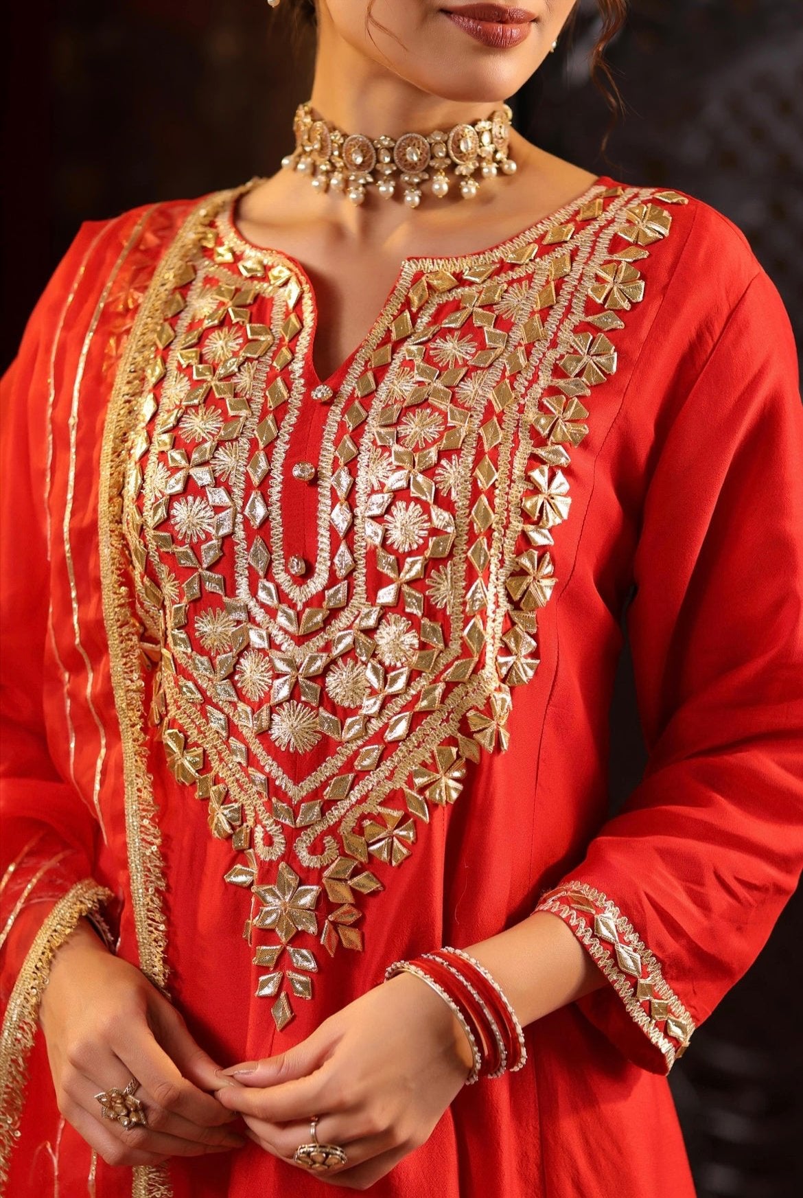 Red Silk Anarkali Salwar Set with Zari, Dori and Gota work. Detail view.