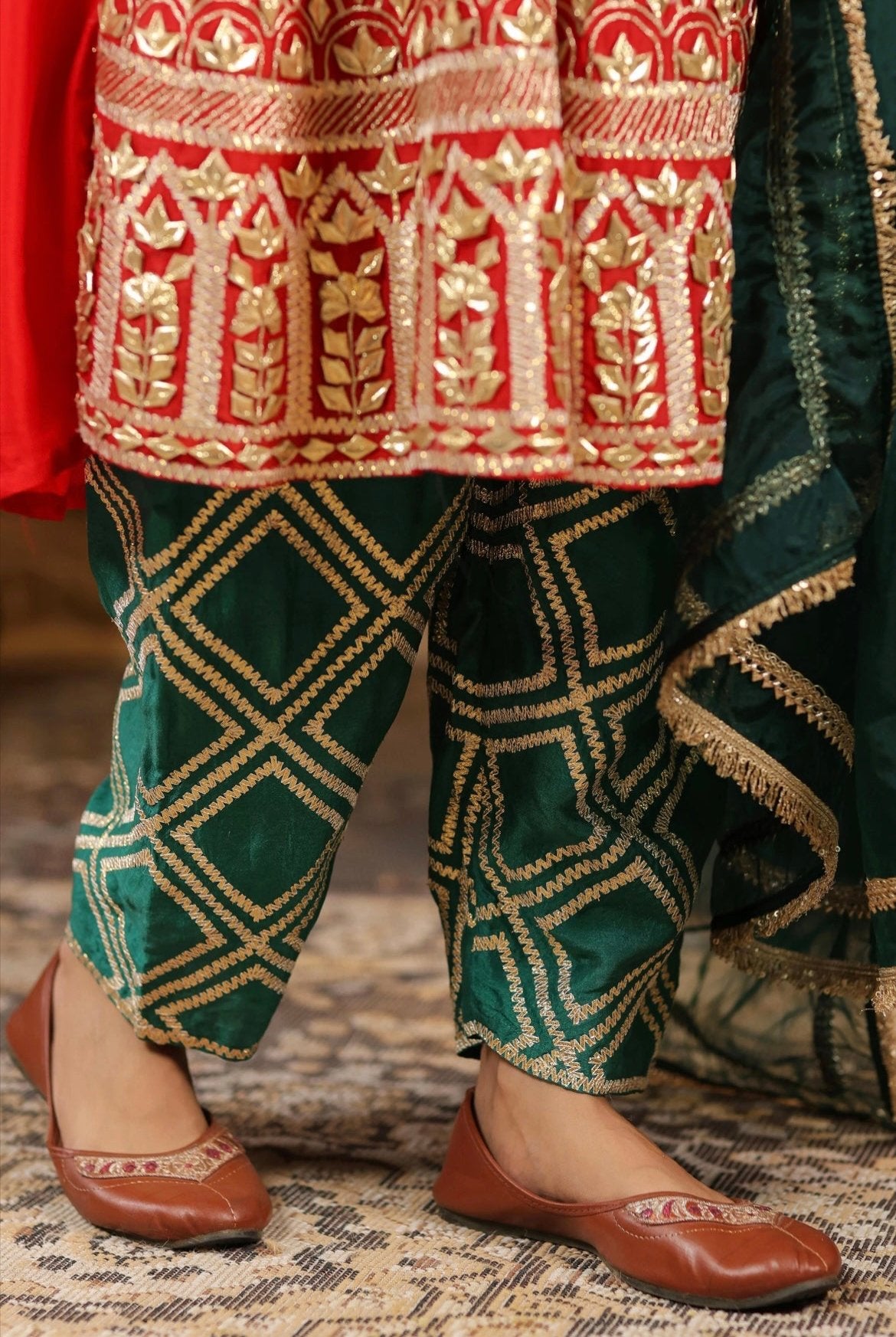 Red and Dark Green Silk Anarkali Salwar Set with Gota embroidery. Detail view.