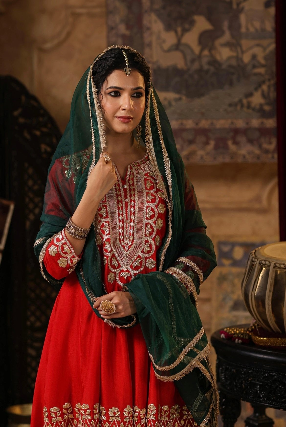 Red and Dark Green Silk Anarkali Salwar Set with Gota embroidery. Half front view.