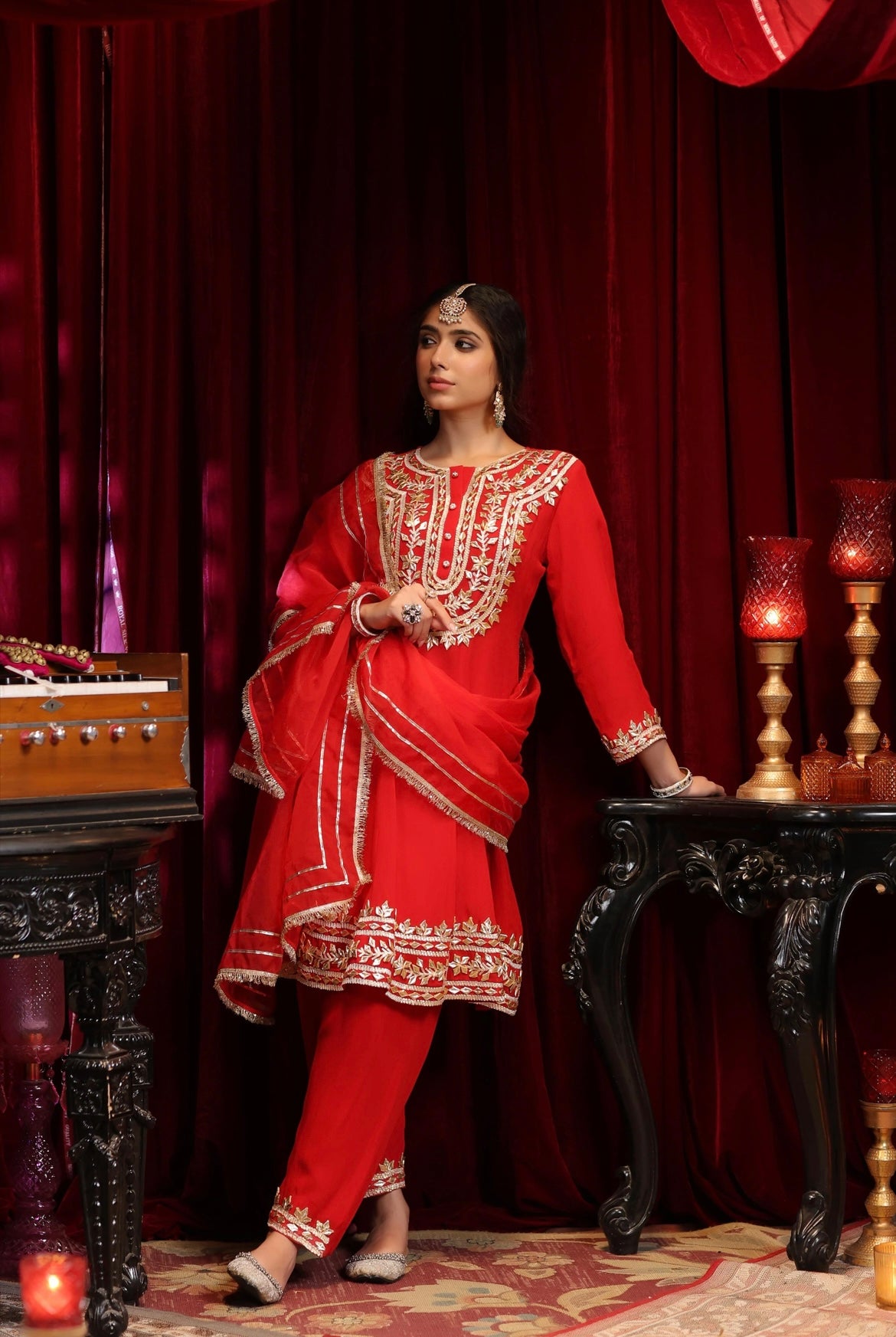 Red Georgette Anarkali and Salwar with Gota atti Embroidery. Organza Dupatta. Side view.